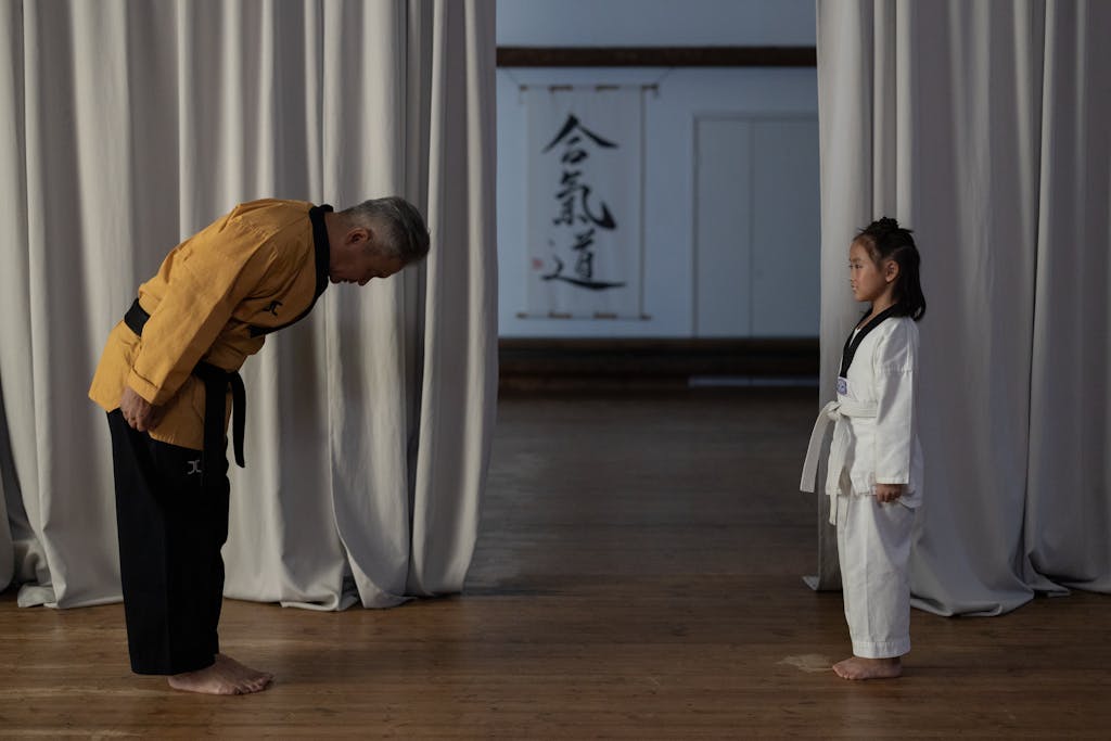 A Martial Arts Instructor Bowing to a Student